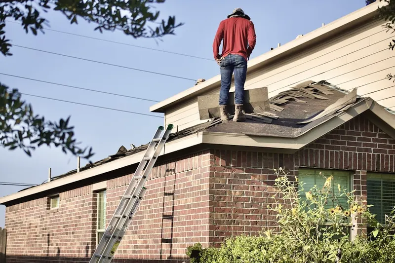 Professional roofer working on a residential roof in Commerce